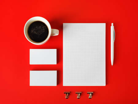 Photo of blank stationery set on red paper background. Corporate identity template. Responsive design mockup. Flat lay.の写真素材