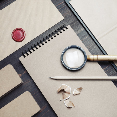 Blank kraft stationery set on wood table background. Business brand template. Branding mock up. Top view. Flat lay.の写真素材