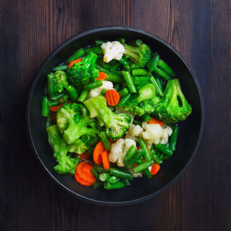 Grilled vegetables in pan on wooden background. Top view. Flat lay.の写真素材