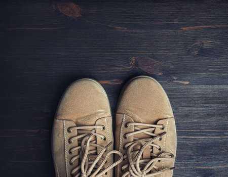 Boots on wooden floor background. Top view. Flat lay.