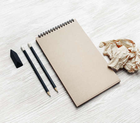 Blank kraft stationery set. Business brand template on light wooden background.