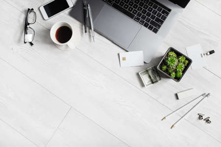 Mix of office supplies and gadgets on wooden background. Copy space for your text. Flat lay.の写真素材