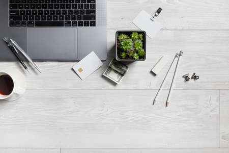 Office workplace with gadgets and stationery on wooden background. Flat lay.の写真素材