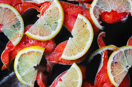 Fresh salmon fish with lemon and seasoning.の写真素材
