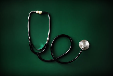 Medical stethoscope on green table background. Flat lay.の写真素材