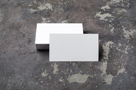 Blank business cards on concrete background. Mockup for branding identity. studio shot.