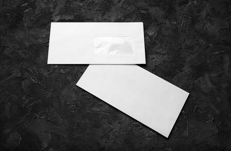 Blank envelope papers on black stone background. front and back side. Template for branding...