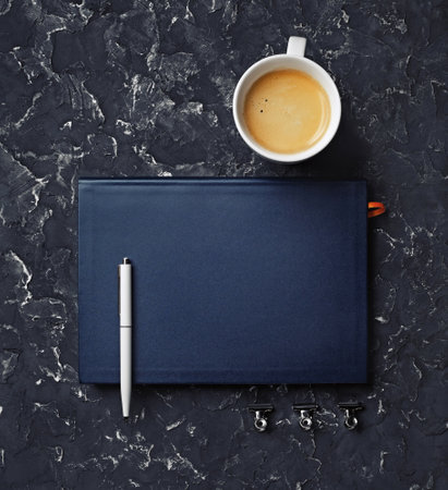 Blank notebook, coffee cup and pen. stationery elements. Template for placing your design. top view.の写真素材