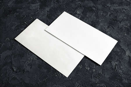 Blank envelope papers on black plaster background. Template for your design.の写真素材