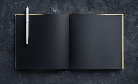 Blank black open sketchbook and pencil. Responsive design template. top view.の写真素材