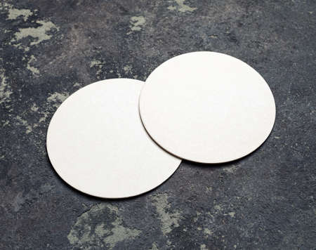 Photo of two blank beer coasters on concrete background. For design presentations and portfolios.の写真素材