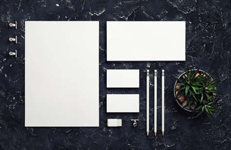 Photo of blank stationery set on black plaster background. corporate identity mockup. Responsive design template. top view. flat lay.の写真素材