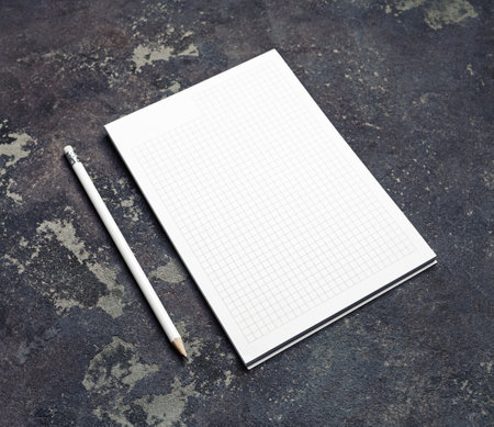 Branding stationery mockup. Copybook and pencil on concrete background. Blank objects for placing your design.の写真素材