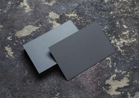 Photo of blank gray business cards stack on concrete background. Branding mockup.の写真素材