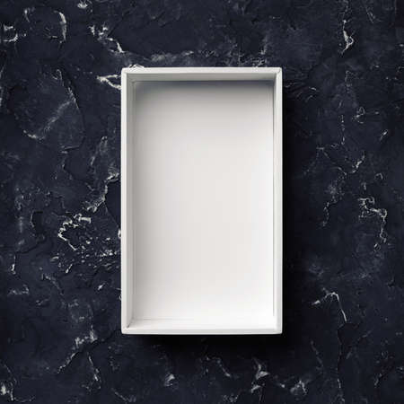 blank package mockup. White paper box on black plaster background. top view.の写真素材