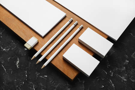 Blank corporate stationery template and wooden board. Mockup for design presentations and portfolios.の写真素材