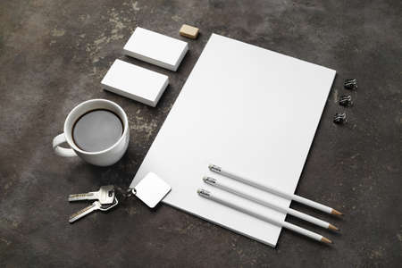 Blank stationery, key and coffee cup on concrete background. ID template. Mockup for branding identity for designers.の写真素材