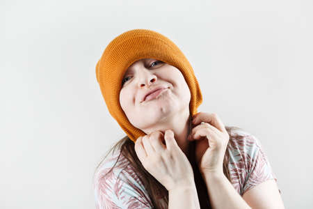 Smiling hipster woman pulled a knitted hat over her ears.の写真素材