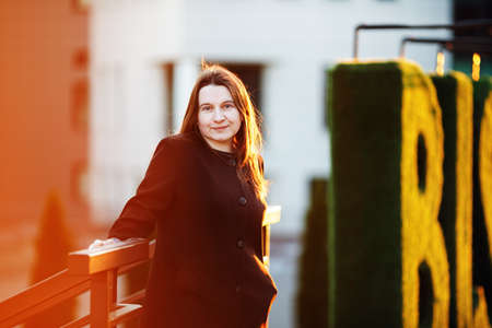 Portrait of a woman in an urban setting. Sunset lighting. Business woman in the city. selective focus.の写真素材
