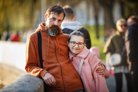 Portrait of a teenage daughter with dad outdoors. Selective focus on the girl.の写真素材