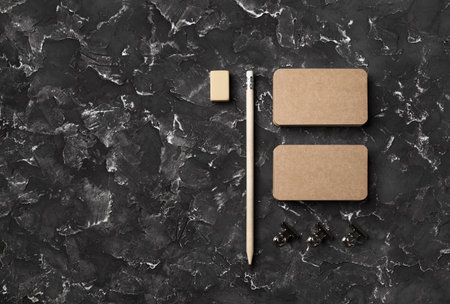 Blank kraft business cards, pencil, eraser and clips. Template for branding identity. flat lay.の写真素材