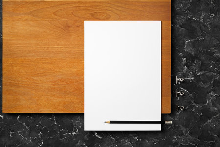 Blank white letterhead and pencil. Branding template on wooden board background.の写真素材
