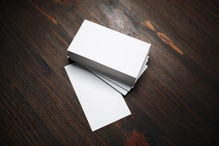 Photo of blank business cards on wood table background. Mock-up for branding identity for designers.の写真素材