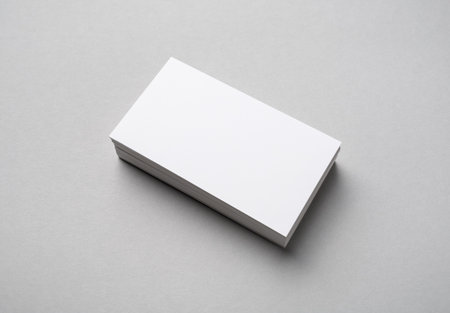 Stack of blank business cards on gray paper background. Branding mockup.の写真素材