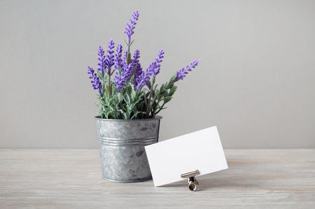 Photo of blank business card and tin bucket with artificial lavender.の写真素材