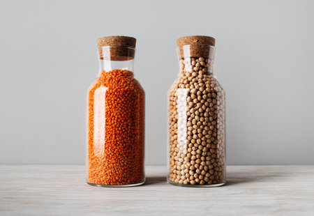 Bulgur and lentils in glass jars with cork lids.の写真素材
