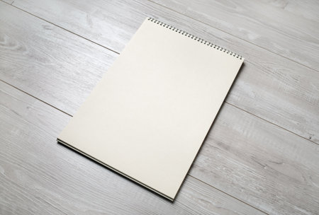 Blank notepad for sketching on wooden background. Sketchbook with spiral. Free space.の写真素材