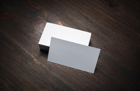 Photo of blank business cards on wood background. For design presentations and portfolios. Mock-up for branding identity.の写真素材