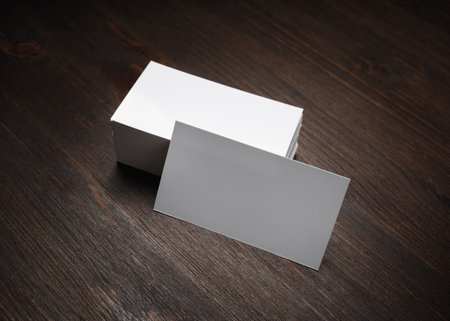 Blank business cards on wooden background. Mockup for branding identity.の写真素材