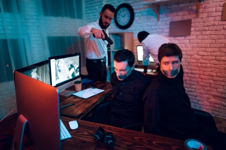 The thieves attacked the guards in the security room. They tied the guards with an adhesive tape.の写真素材