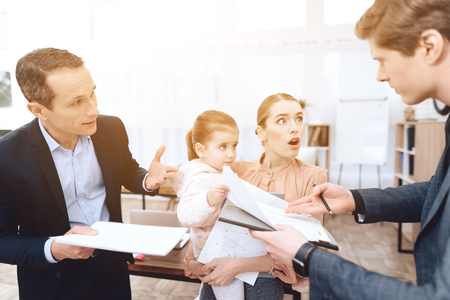 Men have a complaint about a woman who came with her daughter to work. This is a business office.の写真素材
