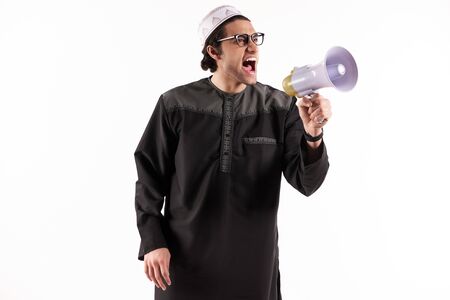 Arab man speaks in megaphone. Announcements concept. Isolated on white background.の写真素材