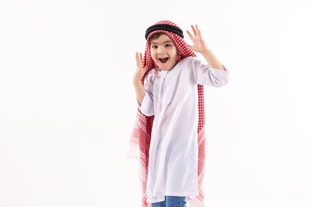 Arabian boy in keffiyeh expresses surprise. Isolated on white background. Studio portrait.の写真素材