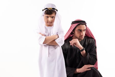 Arab adult man in keffiyeh in quarrel with son. Parenthood concept. Isolated on white background.の写真素材