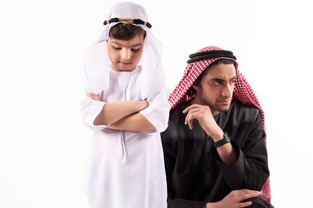 Arab adult man in keffiyeh in quarrel with son. Parenthood concept. Isolated on white background.の写真素材