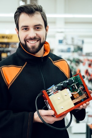 Map is posing with uninterruptible power supply, ups model in aisle of power tools store.