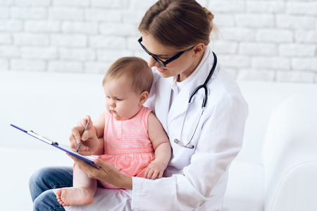 Professional pediatrician doctor exam newborn. Healtcare, pediatry concept.の写真素材