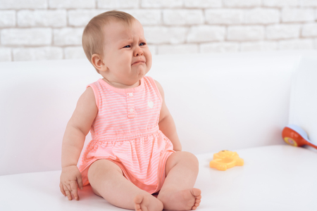 Little newborn baby pink dressed crying bitterly. Newborn concept.の写真素材