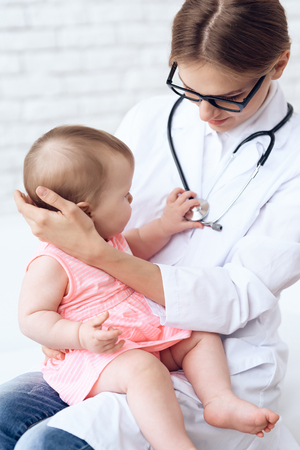 Pediatrician doctor play with newborn. Healtcare, pediatry concept.の写真素材