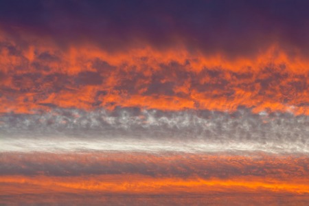 Orange clouds. Sinister sunset background texture nature