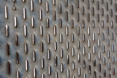Perforated sheet of iron with oval oblong holes, backgroundの写真素材