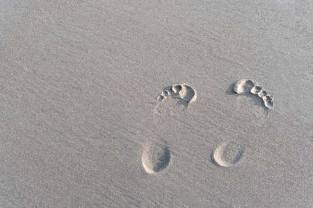 footprints of a man on white sand, at seaの写真素材