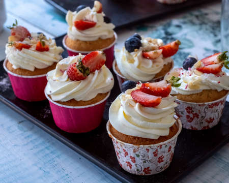 Muffins with strawberries in baking dish.の写真素材