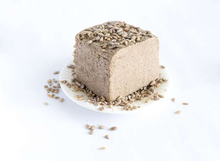 halva from sunflower seeds on a white plate. national traditional sweetness of turkish halva on the tableの写真素材