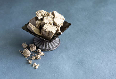 halva from sunflower seeds on a plate. national traditional sweetness of turkish halva on gray...
