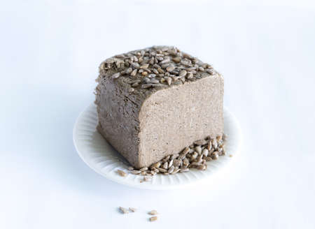 halva from sunflower seeds on a white plate. national traditional sweetness of turkish halva on the table. High quality photoの写真素材